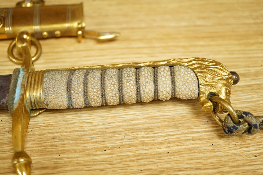 A post 1901 British naval officer’s dirk, the locket engraved with owners initials ‘CHCO’R’, regulation gilt brass mounts, with wire bound fish skin grip, bullion dress knot, in its original scabbard, blade etched with c